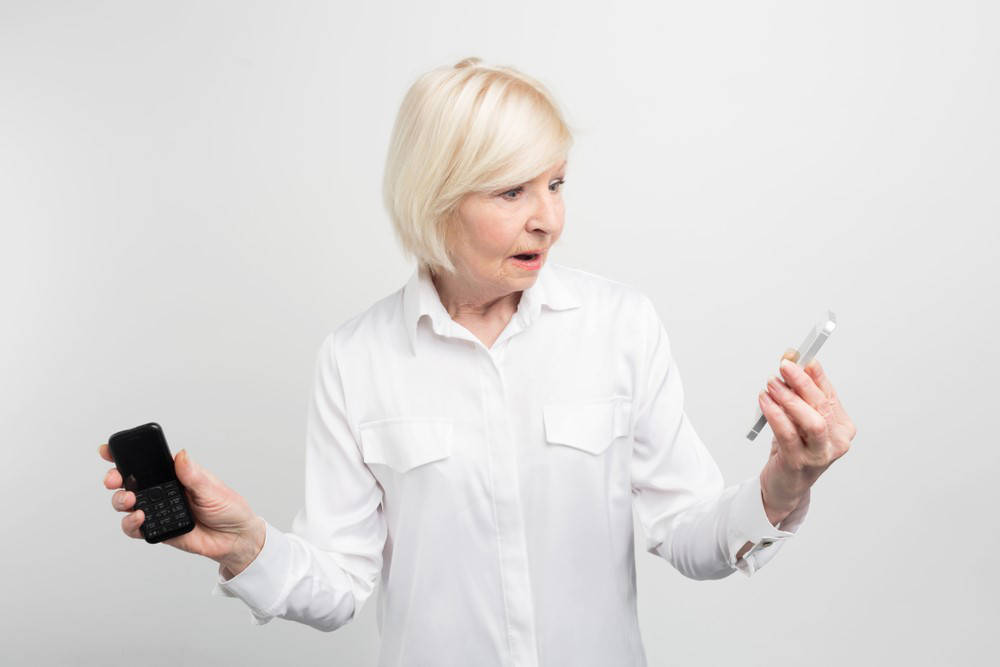 older woman with two phones